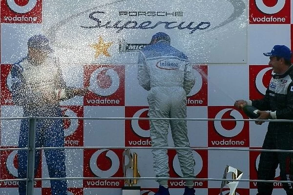 Porsche Supercup: Alexander Davison Manthey Racing 2nd, race winner Marco Werner Team Farnbacher and Christophe Bouchut spray champagne on the podium