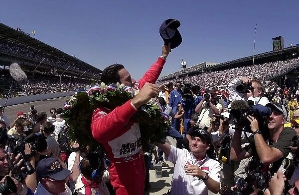 Race winner Helio Castroneves (BRA) Team Penske waves to the 300, 000 plus fans following his back-to back Indy success Indianapolis 500, Indianapolis, USA, 26 May 2002 DIGITAL IMAGE