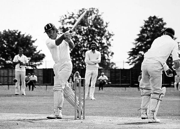 Racing drivers cricket match. Graham Hill enjoys a game of cricket, portrait