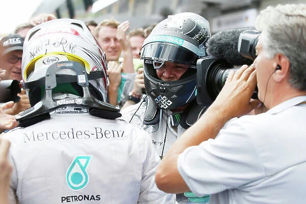 Red Bull Ring, Spielberg, Austria. Sunday 22 June 2014. Nico Rosberg, Mercedes AMG, 1st Position, and Lewis Hamilton, Mercedes AMG, 2nd Position, celebrate in Parc Ferme. World Copyright: Charles Coates / LAT Photographic. ref: Digital Image _N7T4986