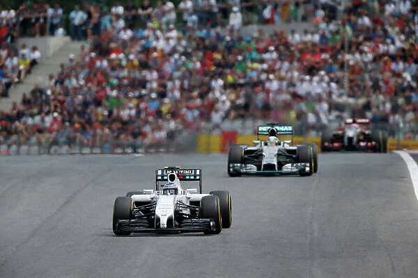 Red Bull Ring, Spielberg, Austria. Sunday 22 June 2014. Valterri Bottas, Williams FW36 Mercedes, leads Lewis Hamilton, Mercedes F1 W05 Hybrid, and Romain Grosjean