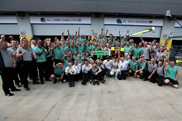 Red Bull Ring, Spielberg, Austria. Sunday 22 June 2014. Nico Rosberg, Mercedes AMG, 1st Position, and Lewis Hamilton, Mercedes AMG, 2nd Position, celebrate victory with their team. World Copyright: Sam Bloxham / LAT Photographic. ref