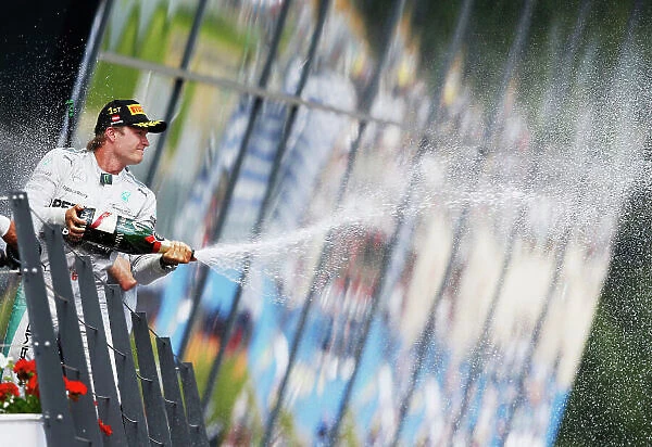 Red Bull Ring, Spielberg, Austria. Sunday 22 June 2014. Nico Rosberg, Mercedes AMG, 1st Position, celebrates on the podium. World Copyright: Steven Tee / LAT Photographic. ref: Digital Image _X0W0910