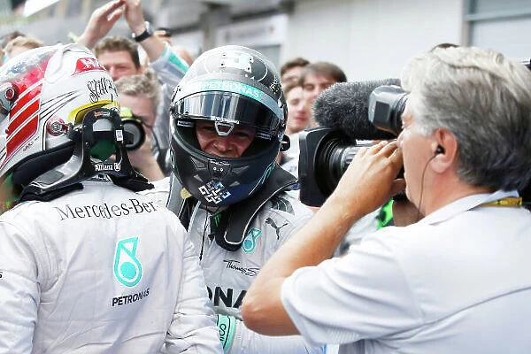 Red Bull Ring, Spielberg, Austria. Sunday 22 June 2014. Nico Rosberg, Mercedes AMG, 1st Position, and Lewis Hamilton, Mercedes AMG, 2nd Position, celebrate in Parc Ferme. World Copyright: Charles Coates / LAT Photographic. ref