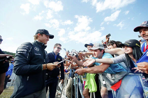 Red Bull Ring, Spielberg, Austria. Saturday 21 June 2014. Nico Rosberg, Mercedes AMG, signs autographs for fans. World Copyright: Charles Coates / LAT Photographic. ref: Digital Image _J5R9881