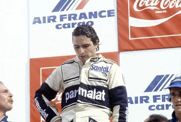 Rio de Janeiro, Brazil. 21 March 1982: Nelson Piquet, Brabham BT49D-Ford, disqualified, exhausted on the podium. Keke Rosberg, Williams FW07C-Ford
