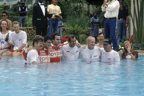Safari Rally, Kenya. 11-16 April 1990: Toyota team celebrate including Luis Moya, Carlos Sainz, Bjorn Waldegard, Fred Gallagher in the swimming pool