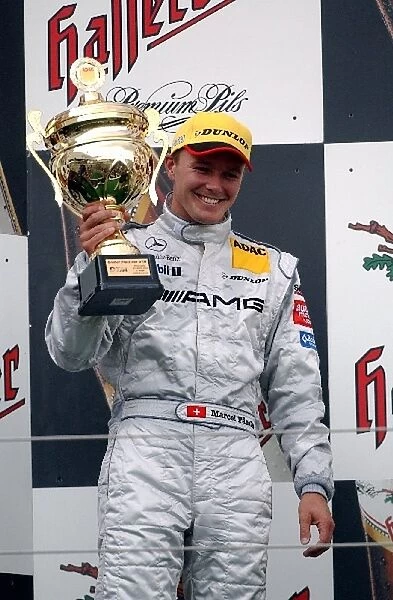Second placed Marcel Faessler (SUI), AMG-Mercedes, holding up his trophy