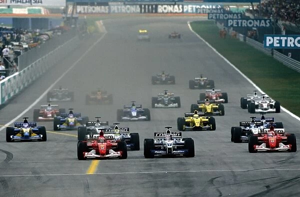 Sepang, Malaysia. 15th - 17th March 2002: Michael Schumacher, Juan Pablo Montoya and Rubens Barichello battle for the lead at race start