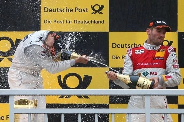 DTM. L-R: Shower of champagne for race winner Bruno Spengler 