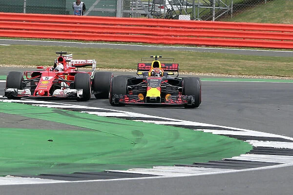 Silverstone, Northamptonshire, UK. Saturday 15th July 2017. Sebastian Vettel, Ferrari SF70H battles with Max Verstappen (NLD) Red Bull Racing World Copyright: JEP / LAT Images