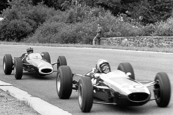 Spa-Francorchamps, Belgium. 14 June 1964: Bruce McLaren, Cooper T73-Climax, 2nd position, leads Graham Hill, BRM P261, 5th position, action