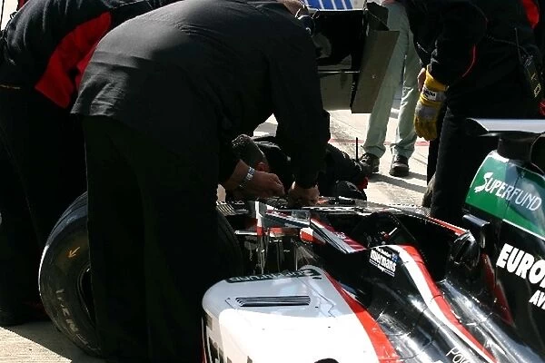 Thunder at the Rock: The Minardi team remove the damaged car of Paul Stoddart