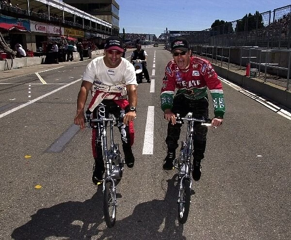 Tony Kanaan and Adrian Fernandez pedal to their cars prior to qualifying for the Molson Indy Montreal. Circuit Gilles Villeneuve, Montreal, Quebec, Can. 23