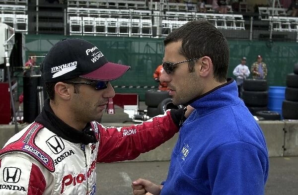 Tony Kanaan and Dario Franchitti talk it over in the pits prior to Saturday morning practice for the G.I. Joes 200. Portland International Raceway, Portland, Or. 16 June, 2002