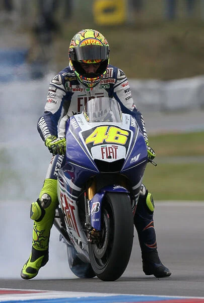 Valentino Rossi Fiat Yamaha Team performs a rolling burn-out for his fans after his