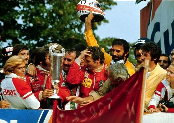 The winners celebrate on the podium in Monza. Race winner Clay Reggazoni