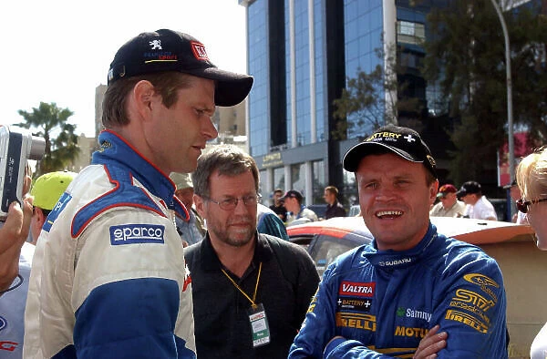 World Rally Championship, Cyprus Rally, April 18-21, 2002. Marcus Gronholm and Tommi Makinen discuss Stage 12 which suffered very heavy rain during the stage. Photo: Ralph Hardwick / LAT