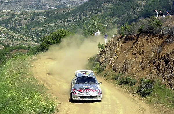 World Rally Championship, Cyprus Rally, April 18-21, 2002. Gilles Panizzi on Stage 6, Leg 1, his Peugeot 206 WRC showing damage from a roll on Stage 3. Photo: Ralph Hardwick / LAT