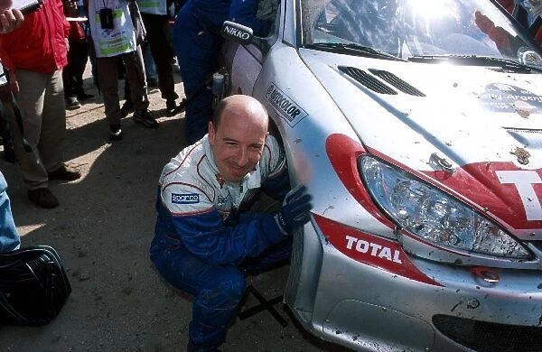 World Rally Championship: Didier Auriol hit a rock, resulting in ripping a wheel off his Peugeot