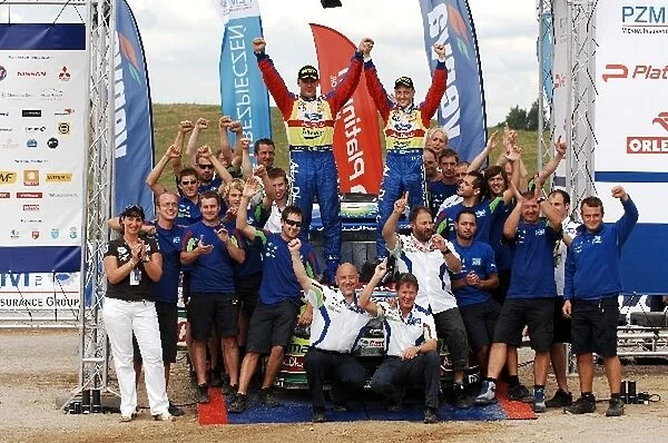 World Rally Championship: The Ford team celebrate on the podium after Mikko Hirvonen took victory