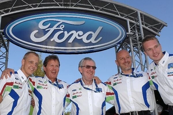 World Rally Championship: Ian Slater Vice President communications Ford of Europe, centre, with Malcolm Wilson MSport CEO 2nd from left, following