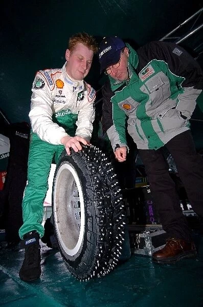 World Rally Championship: Janne Tuohino Skoda and Martin Muhlmeier Skoda Team Director examine a studded tyre