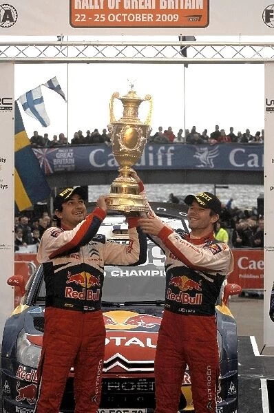 World Rally Championship: L-R: Rally winners and champions for the sixth time, Sebastien Loeb and L-Daniel Elena, Citroen, with the winners