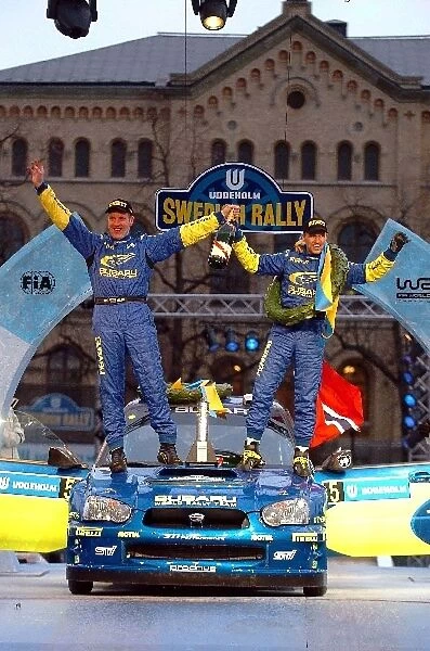World Rally Championship: Rally winners Phil Mills and Petter Solberg Subaru celebrate victory on the podium