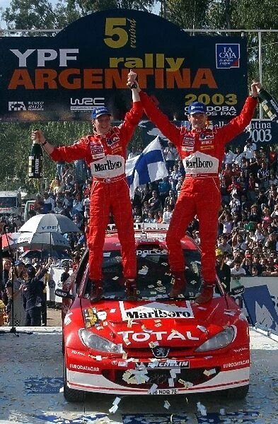 World Rally Championship: The rally winning crew of Marcus Gronholm  /  Timo Rautiainen Peugeot 206 WRC celebrate their 15th rally win on the podium