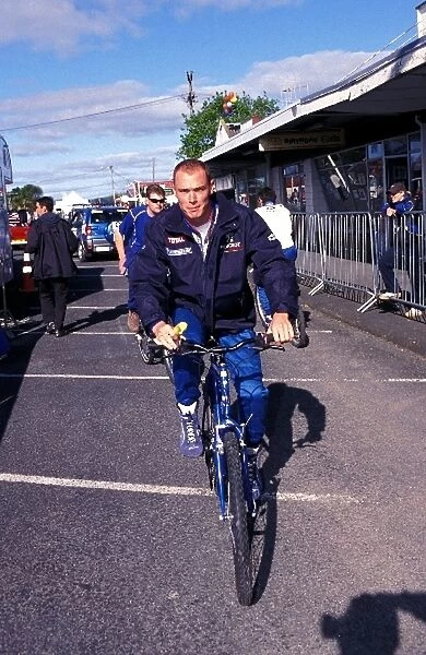 World Rally Championship: Richard Burns Peugeot, cycles through the service area after losing his World Championship crown to team mate Marcus