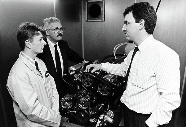 A young Allan McNish visits his new sposors, Gates of Dumfries, with Manager Robert Denholm (left) and Development Engineer Fraser Lacey (Right). Portrait. Ref: B / W Print