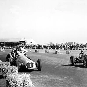 1950 British Grand Prix - Geoffrey Crossley and B. Bira: Geoffrey Crossley passes the retiring B. Bira"
