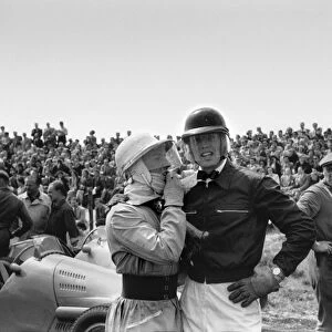 1953 Dutch Grand Prix: Stirling Moss, 9th position, talks to Mike Hawthorn, 4th position, at the start, portrait
