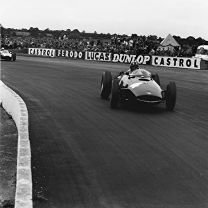 1960 British Grand Prix: Graham Hill, retired, leads Jack Brabham, 1st position, action