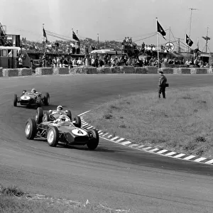 1960 Dutch Grand Prix. Zandvoort, Holland. 6th June 1960. Innes Ireland (Lotus 18-Climax), 2nd position leads Stirling Moss (Lotus 18-Climax), 4th position and Alan Stacey (Lotus 18-Climax), retired, action. World Copyright: LAT Photographic