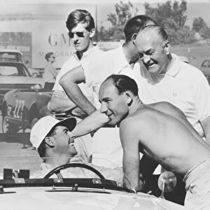 1961 3 hour Production Car Race: Stirling Moss / Jack Brabham, 3rd position, chat in the pits, portrait
