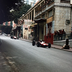 1965 Monaco Grand Prix - Lorenzo Bandini and John Surtees: Lorenzo Bandini leads John Surtees. They finished in 2nd and 4th positions respectively