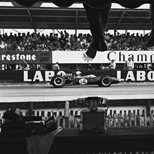 1966 French Grand Prix: Denny Hulme, 3rd position, passes the pits, action