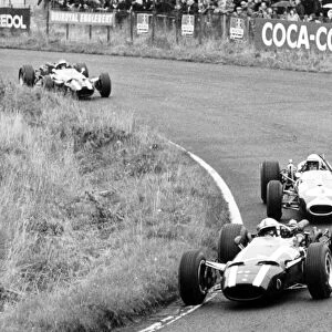 1966 German Grand Prix: John Surtees, Cooper T81-Maserati, 2nd position, leads Jack Brabham, Brabham BT19-Repco, 1st position