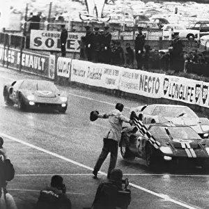 1966 Le Mans 24 Hours: Moment of victory for Fords, the 7 litre Ford GT40 of Bruce McLaren and Chris Amon, crosses the finish line to lead a