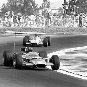 1968 Mexican Grand Prix - Graham Hill and Jackie Stewart: Graham Hill, Lotus 49B-Ford, 1st position, leads Jackie Stewart, Matra MS10-Ford, 7th position