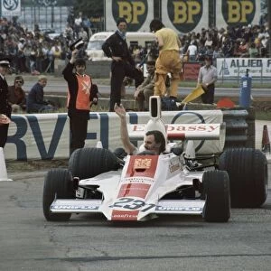 1975 British Grand Prix - Graham Hill: Graham Hill, Embassy Hill GH1 Ford, waves to the crowd during a demonstration lap