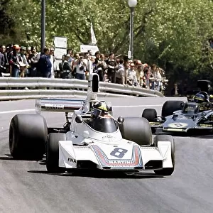 1975 Spanish Grand Prix. Montjuich Park, Spain. 27 April 1975. Carlos Pace, Brabham BT44B-Ford, retired, leads Ronnie Peterson, Lotus 72E-Ford, retired, action. World Copyright: LAT Photographic Ref: 35mm transparency 75SPA