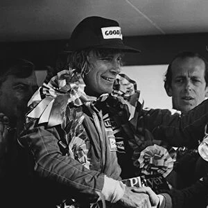 1976 British Grand Prix: James Hunt, Disqualified and Niki Lauda, 1st position celebrate on the podium, portrait