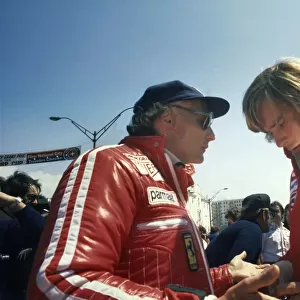 1976 United States Grand Prix West: Niki Lauda and James Hunt talk in the pits before the race, portrait