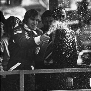 1977 Race of Champions: James Hunt, 1st position, sprays Champagne on the podium, portrait