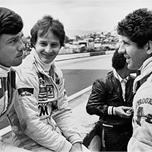 1979 Austrian Grand Prix: Gilles Villeneuve chats with team mate Jody Scheckter and Patrick Tambay in the pits, portrait