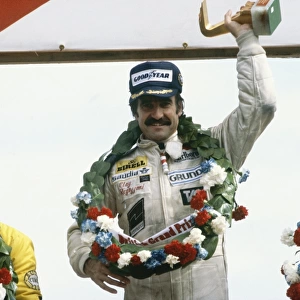 1979 British Grand Prix: Clay Regazzoni, 1st position and Rene Arnoux, 2nd position with Jean-Pierre Jarier, 3rd position, celebrate on the podium