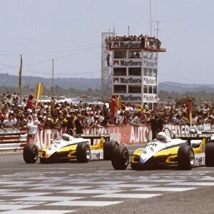 1982 French Grand Prix: Rene Arnoux and Alain Prost lead the rest of the field away from the front row at the start